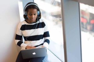 woman-transcribing-audio- files-on-laptop